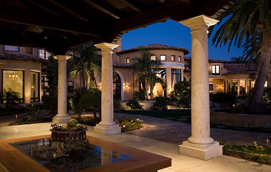 Elegant villa courtyard at twilight with columns and lush landscaping. Elegant villa courtyard at twilight with columns and lush landscaping.